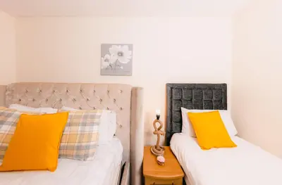 two beds sitting next to each other in a bedroom at Charming and Spacious City Getaway 3 in Edinburgh