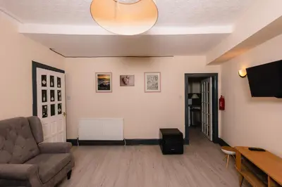 a living room with a couch and a tv at Charming and Spacious City Getaway 3 in Edinburgh