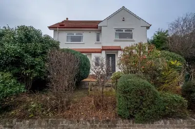 a white house with bushes in front of it at Spacious 5-Bed Home with Garden Parking - Pass the Keys in Edinburgh
