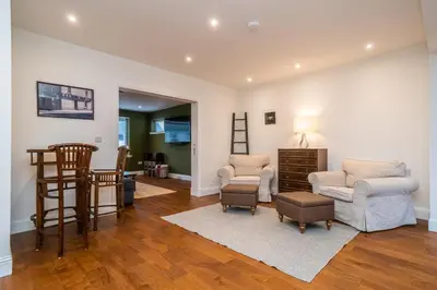 a living room with two chairs and a table at Spacious 5-Bed Home with Garden Parking - Pass the Keys in Edinburgh
