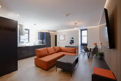 a living room with a couch and a table at Old Kirk Apartment in Oban