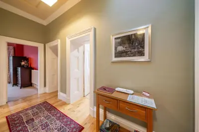 a room with a table and a picture on the wall at Cleish Apartment in Edinburgh