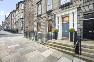a building with a blue door on a street at Goldsmiths Georgian Residence in Edinburgh