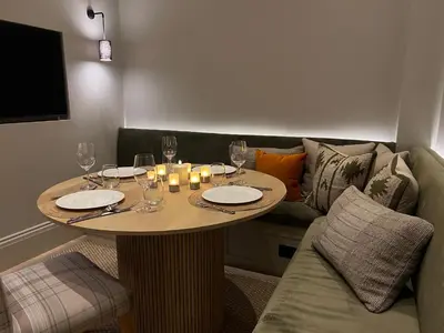 a table with wine glasses and candles and a couch at Goldsmiths Georgian Residence in Edinburgh
