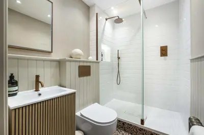 a bathroom with a shower and a toilet and a sink at Goldsmiths Georgian Residence in Edinburgh