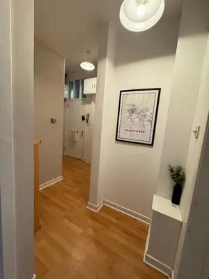 a hallway with white walls and wood floors and a picture on the wall at West-End 2 Bed Flat Entire Place w Free Parking in Glasgow