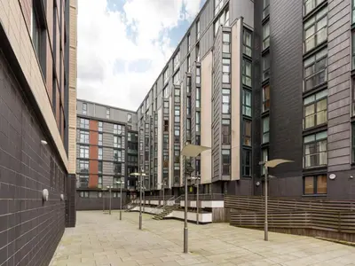 a row of street lights in front of a building at City centre luxury apartment in Glasgow