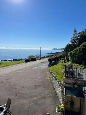 an empty street next to the ocean with a road at The Corrie Hotel in Corrie