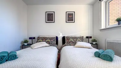 two beds sitting next to each other in a room at Wonderfull stays new property near Glasgow 2 bedrooms in Dalmuir