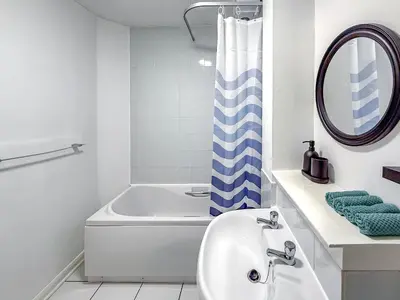 a white bathroom with a tub and a sink at Wonderfull stays new property near Glasgow 2 bedrooms in Dalmuir