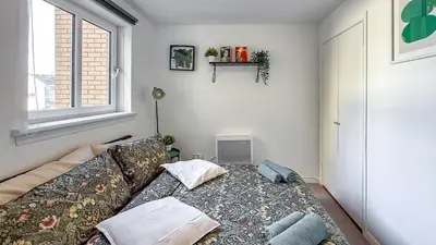 a living room with a couch and a window at Wonderfull stays new property near Glasgow 2 bedrooms in Dalmuir