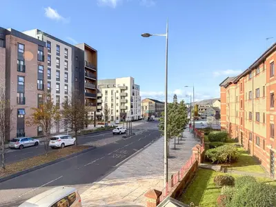 a view of a city street with buildings and cars at Wonderfull stays new property near Glasgow 2 bedrooms in Dalmuir