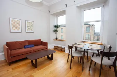 a living room with a couch and a table at Stylish Southside 2 Bedroom Flat with Free Parking in Glasgow