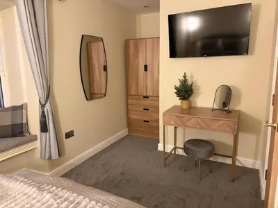 a bedroom with a desk and a television on the wall at Corner House, newly refurbished, Dunning in Dunning