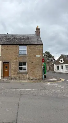 a stop sign in front of a brick building at Corner House, newly refurbished, Dunning in Dunning