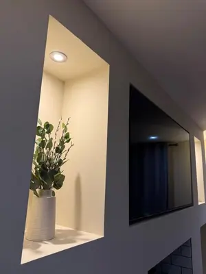 a room with a mirror and a vase with a plant at Corner House, newly refurbished, Dunning in Dunning
