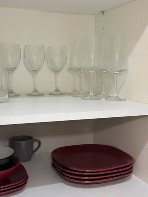 a shelf with wine glasses and plates on it at The Telford Nook in Edinburgh