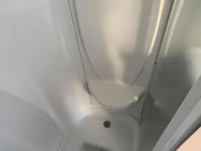 a shower with a white sink in a bathroom at Turnberry Holiday Park Amazing Sea View in Girvan