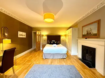 a bedroom with a bed and a fireplace at Cozy 1 bed Garden flat in the New Town City Centre in Edinburgh
