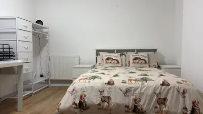 a bedroom with a bed and a dresser at Large double room in a house at Glasgow Westend in Knightswood