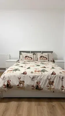 a bedroom with a bed with a bedspread with animals on it at Large double room in a house at Glasgow Westend in Knightswood
