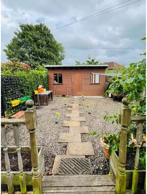 a garden with a stone pathway in front of a house at Large double room in a house at Glasgow Westend in Knightswood