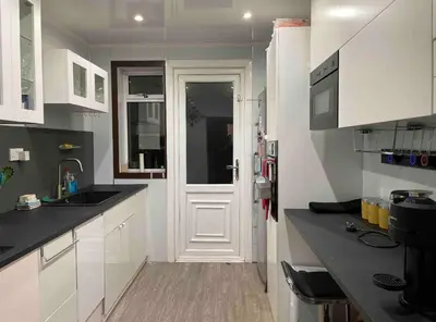 a kitchen with white cabinets and a white door at Large double room in a house at Glasgow Westend in Knightswood