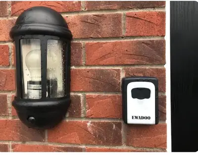 a light on the side of a brick wall at NG Property in Glasgow