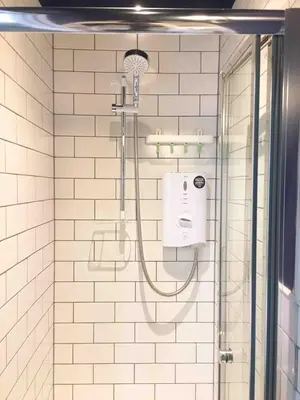 a bathroom with a shower with a soap dispenser at Fully licensed studio in peaceful neighbourhood in Edinburgh
