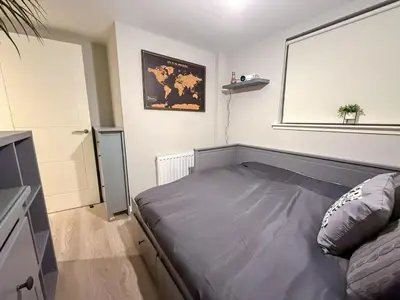 a small bedroom with a bed and a window at 2-Bed Flat in Glasgow East End in Glasgow