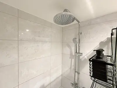 a bathroom with a shower and a shower head at 2-Bed Flat in Glasgow East End in Glasgow