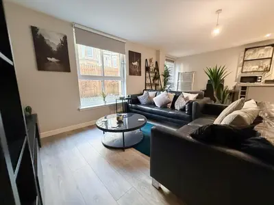 a living room with a couch and a table at 2-Bed Flat in Glasgow East End in Glasgow