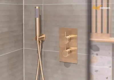 a shower with a shower head in a bathroom at Central 2BR Flat at Wellwynd I Parking Included in Airdrie