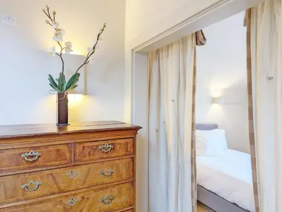 a bedroom with a dresser and a bed at The Granary in Moffat