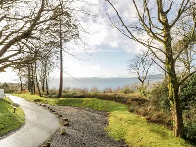a gravel road with trees on either side at Serenity Lodge in Wemyss Bay