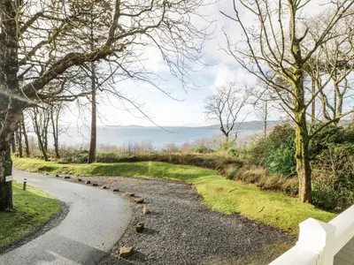 a winding road with trees on either side at Serenity Lodge in Wemyss Bay
