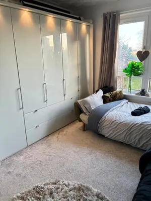 a bedroom with a large bed and a window at 2 bedroom fully furnished apartment in Springburn