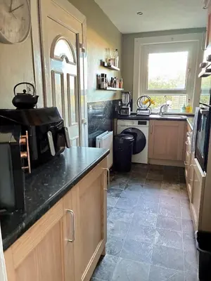 a kitchen with a sink and a microwave at 2 bedroom fully furnished apartment in Springburn
