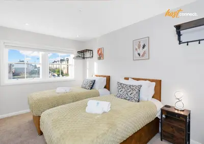 a bedroom with two beds and a window at Comfortable 2 Bed Airdrie Flat w Private Parking in Airdrie