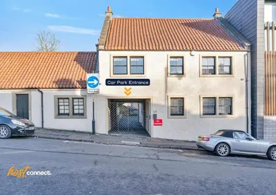 a car parked in front of a building at Comfy 1 Bed Airdrie Flat w Private Parking in Airdrie