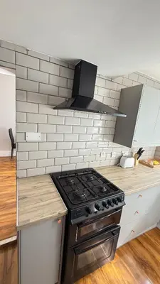 a kitchen with a stove top oven next to a counter at Welcome to your perfect getaway in Glasgow