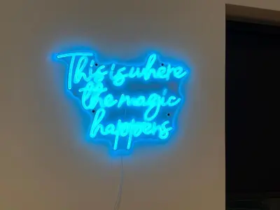 a neon sign that reads this is where the magic happens at The perfect place we call home in Dumbarton