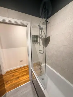 a shower with a glass door in a bathroom at The perfect place we call home in Dumbarton