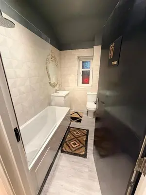 a bathroom with a tub and a toilet at The perfect place we call home in Dumbarton