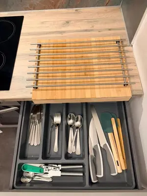 a drawer filled with utensils in a wooden drawer at The perfect place we call home in Dumbarton