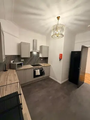 a large kitchen with a chandelier in a room at The perfect place we call home 2 in Dumbarton