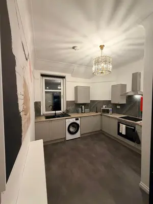 a large kitchen with a washer and dryer in it at The perfect place we call home 2 in Dumbarton