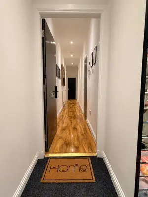 a hallway with a welcome mat on the floor at The perfect place we call home 2 in Dumbarton