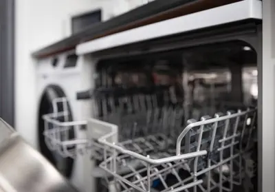 a dishwasher with several dishes sitting inside of it at Broomfield No 31 by Klass Living Airdrie in Airdrie