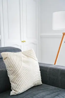 a pillow sitting on a couch in a living room at Elm House in Bathgate